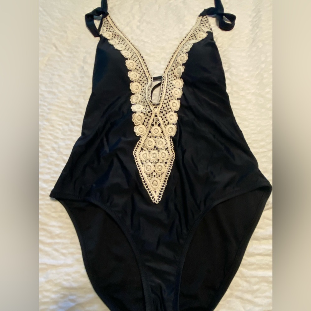Cute!  Black one piece with beautiful crochet insert.  Never worn, nwt.